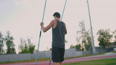 A-tired-javelin-thrower-at-the-stadium-during-training-sticks-a-spear-into-the-ground